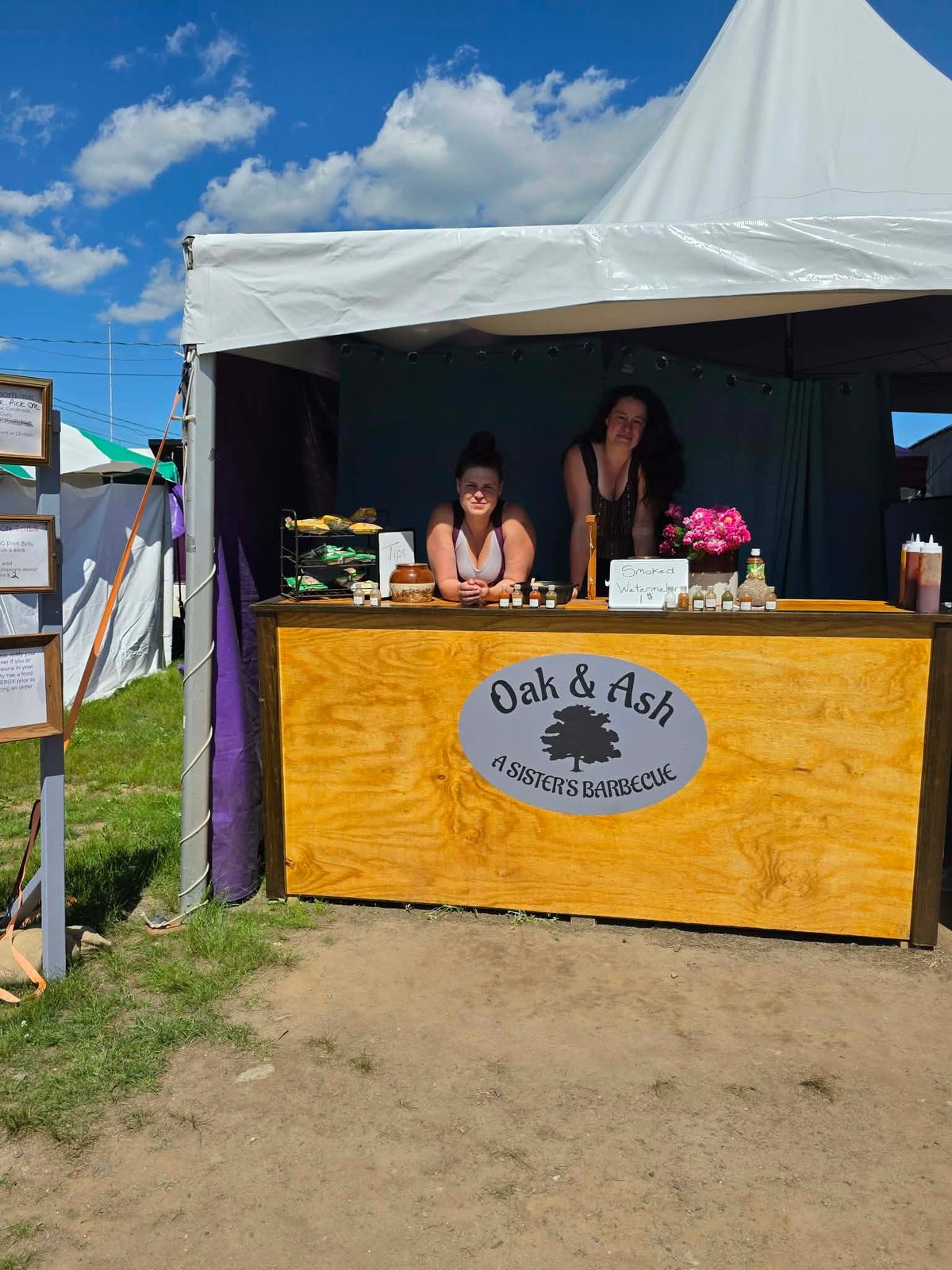 The Oak & Ash booth: a white tent with a wooden counter and the Oak & Ash sign